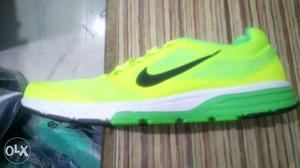 Green And White Nike Running Shoe