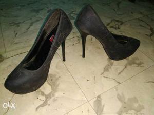 Pair Of Black And Gray Heeled Shoes