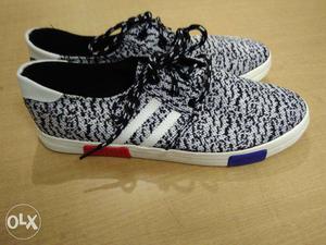 Pair Of White Black And Red Low Top Shoes