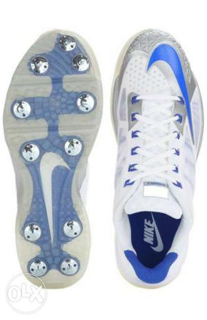 Pair Of White-and-blue Nike cricket spikes