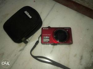 Red Nikon Coolpix Point-and-shoot Camera With Case