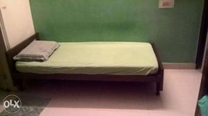 Comfortable standard size single bed with mattress at a