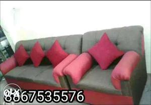 Gray Padded Sofa And Gray Sofa Armchair With Four Pink Throw
