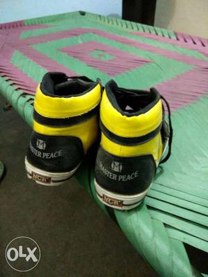 Pair Of Black-and-yellow Master Peace Basketball Shoes