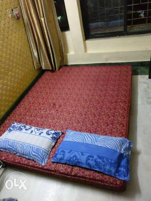 Red Mattress And Two Blue Pillows