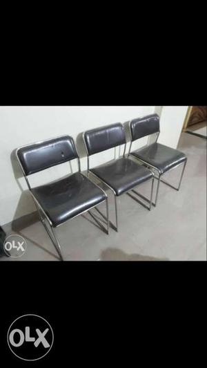 Three Silver And Black Chairs
