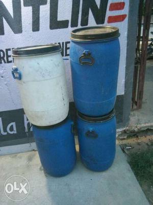 White And Three Blue Plastic Barrels