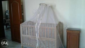 Mee Mee wooden crib with mosquito net. It has 2