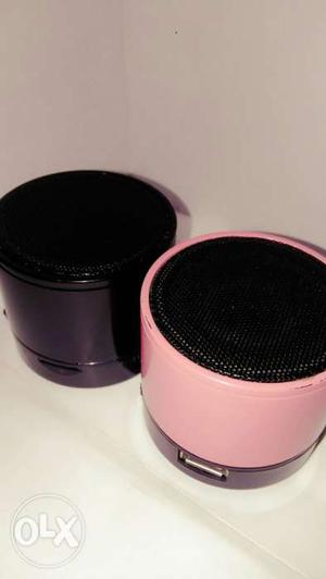 Two Black And Pink Speakers