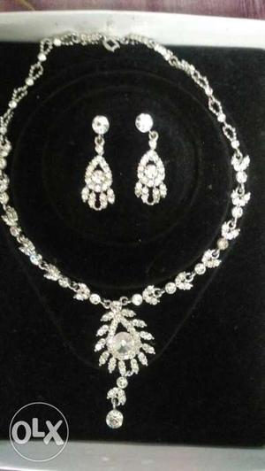 Gently used platinum base white stone necklace
