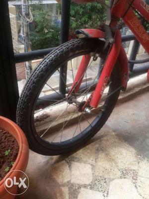 Red Bicycle With Black Bicycle Wheel