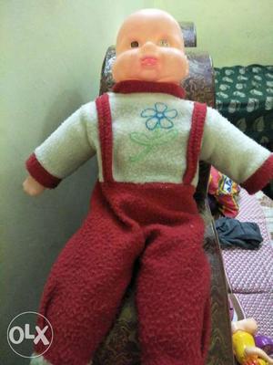 Baby In Green And Red Jumpsuit Doll
