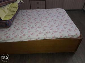 Brown Wooden Bed Frame And Floral Mattress