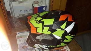 Green, Black, White, And Orange Motocross Helmet