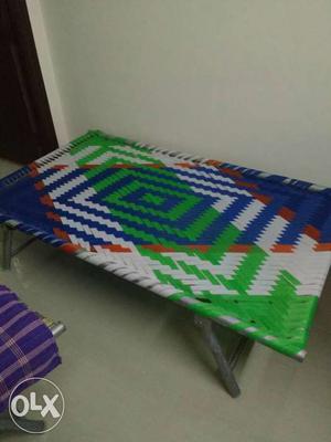 Green, White, And Orange Folding Bed