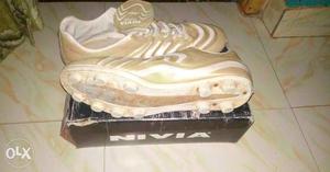 Pair Of Brown Nivia Cleats On Box
