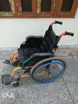 Red, Yellow And Black Wheel Chair