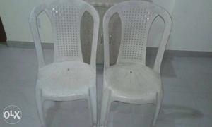 Two White Monobloc Chairs