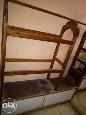 Wooden Clothes hanger with storage unit.