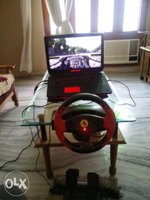 Black And Red Ferrari Racing Wheel; Black Laptop Computer