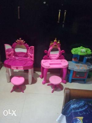 Two Pink Plastic Vanity Tables