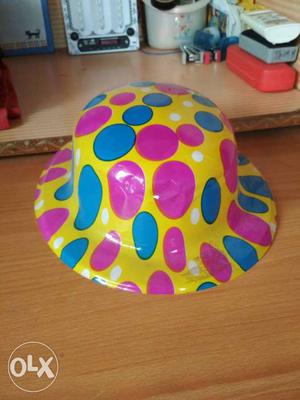 Yellow, Blue, And Pink Plastic Hat