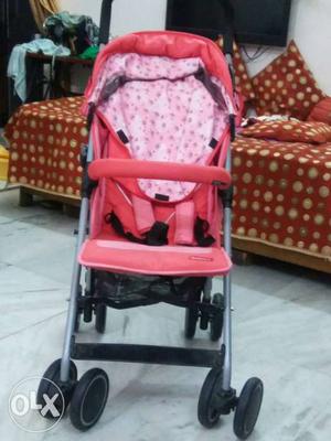 Baby's Pink, Grey, And Black Stroller