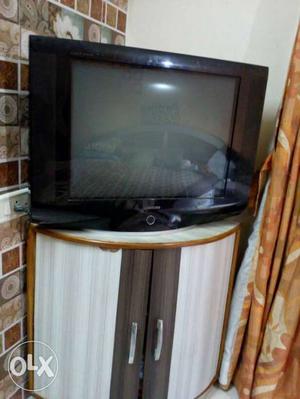 White And Brown Wooden Cabinet With Black CRT TV