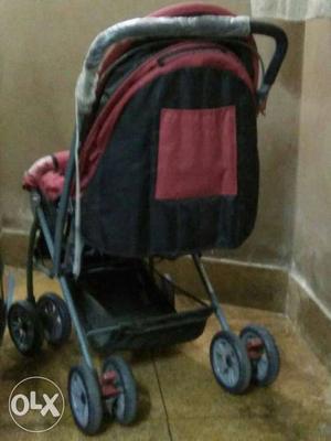 Baby's Red And Black Stroller