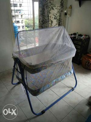 Blue, Pink, And Grey Floral Cradle With Mosquito Net