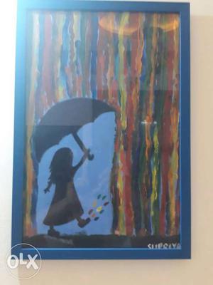 Little girl enjoying colours of rain with Blue Wooden Frame
