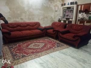 Red Couch And Armchairs With Floor Rug