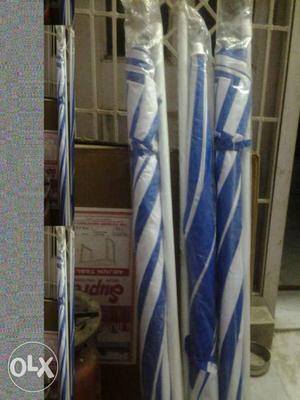 Three Blue-and-white Patio Umbrellas In Packs