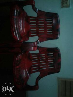 Two Red Plastic Armchairs