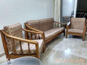 Wooden frame sofa set with cushions.