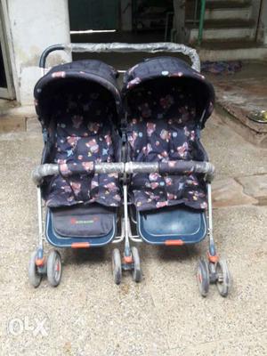 Baby's Blue And Black Twin Strollers