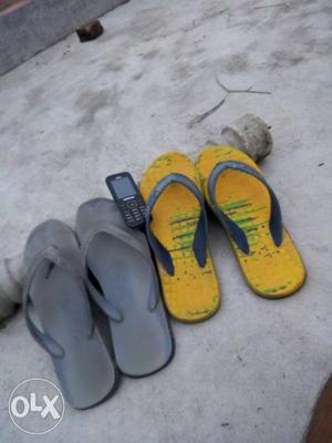 Two Pairs Of Yellow And Gray Flip-flops