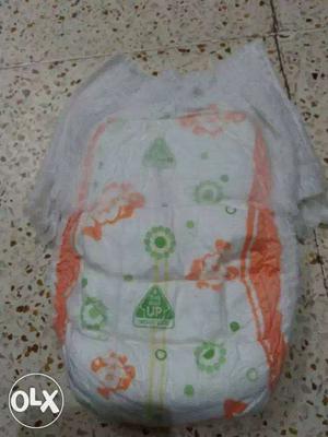 White, Orange, And Green Disposable Diaper Pants