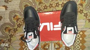 Pair Of Black Fila Sneakers On Box