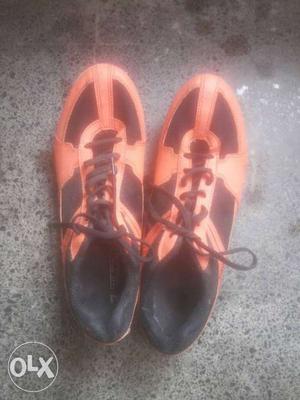 Pair Of Orange-and-black sports shoes