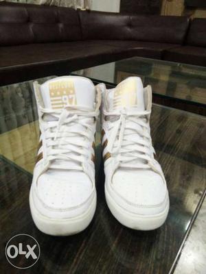 Pair Of White Adidas Mid Top Sneakers