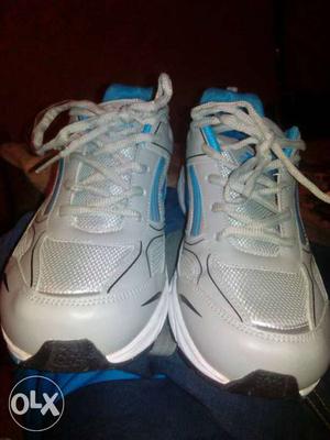 Pair Of White-and-blue Running Shoes