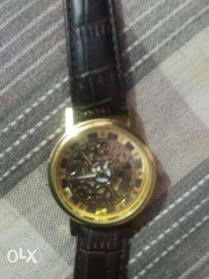 Round Gold Mechanical Watch With Black Leather Strap