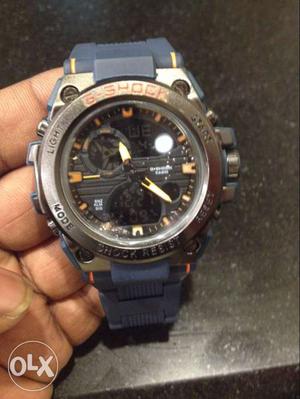 Round Silver G-shock Chronograph Watch With Blue Rubber Link