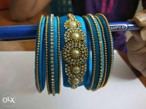 Stone And Pearl Embellished Blue Silk Thread Bangles