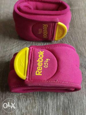 Two Pink-and-yellow Reebok Straps