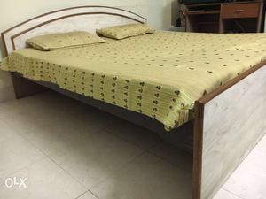 Beautiful wooden bed with mattress