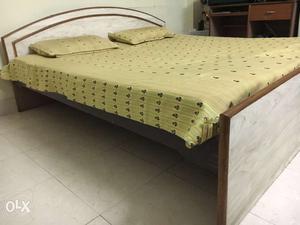Beautiful wooden bed with mattress