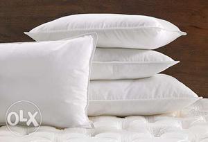 Four White Fabric Pillows
