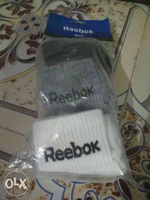 Gray, Black, And White Reebok Socks